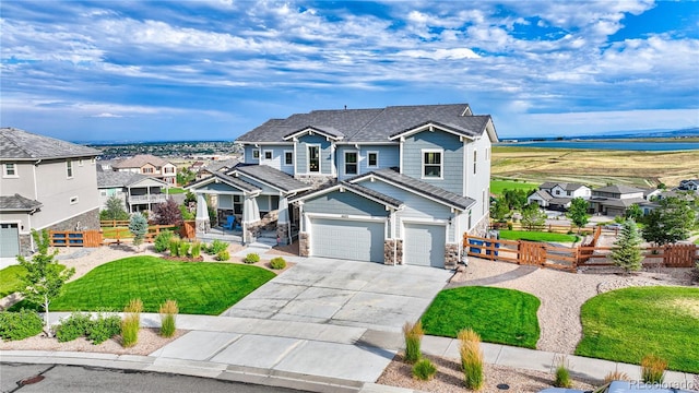 craftsman house featuring a garage and a front lawn