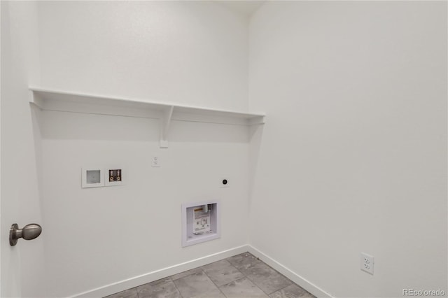 laundry area with laundry area, hookup for a washing machine, electric dryer hookup, and baseboards