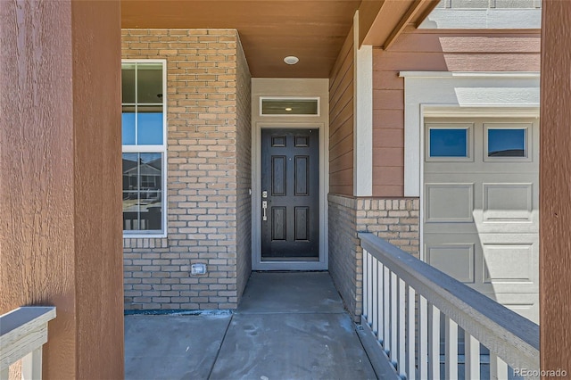 property entrance with brick siding