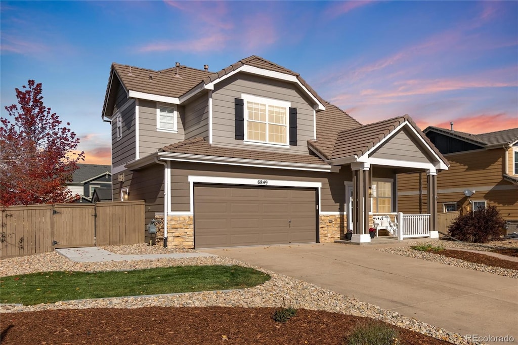 view of front of house featuring a porch and a garage