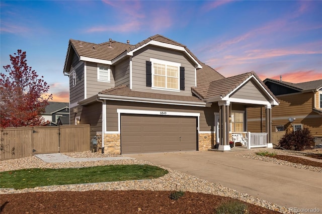 view of front of house featuring a porch and a garage