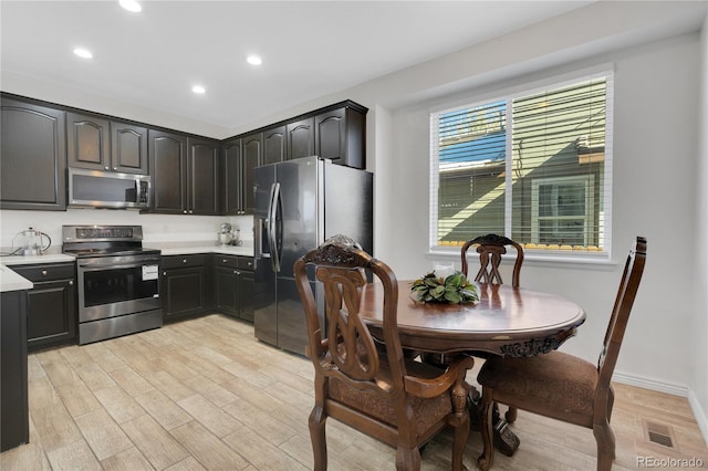 kitchen featuring appliances with stainless steel finishes, light hardwood / wood-style flooring, and a wealth of natural light