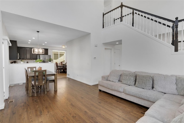 living room featuring dark hardwood / wood-style floors and a chandelier