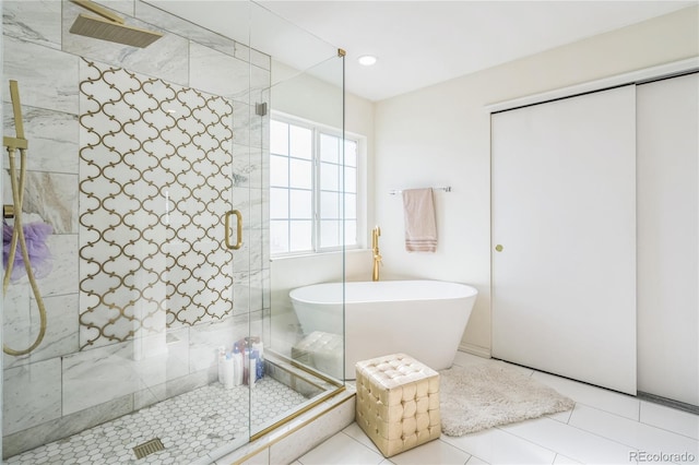 bathroom featuring tile patterned floors and shower with separate bathtub