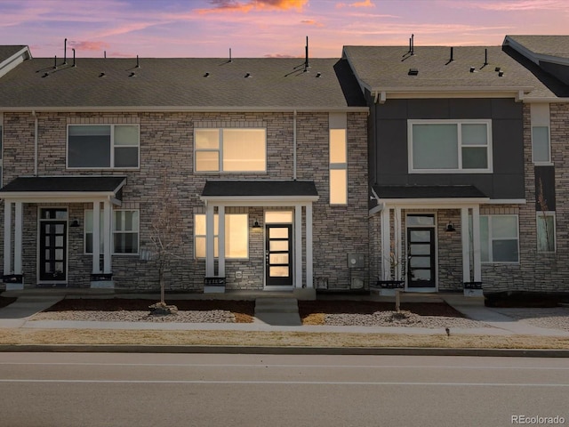 22360 E 8th Ave, Aurora, CO 80018 - view of property with stone siding and a shingled roof