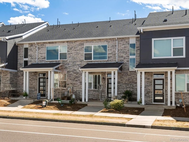 22360 E 8th Ave, Aurora, CO 80018 - townhome / multi-family property featuring a shingled roof and stone siding