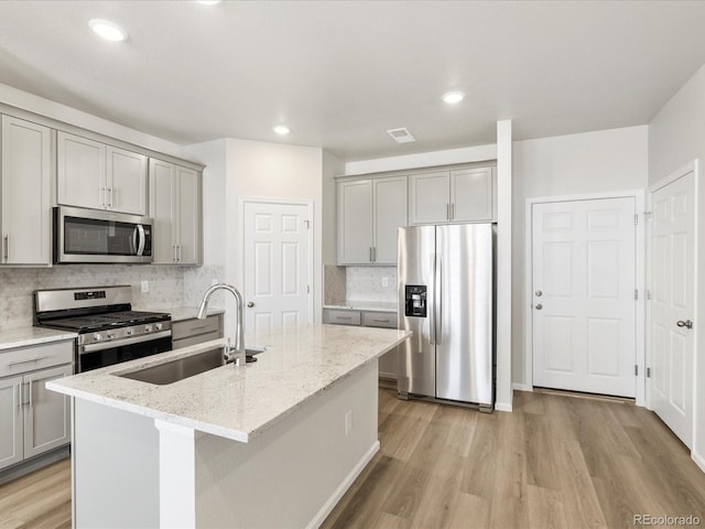 22360 E 8th Ave, Aurora, CO 80018 - kitchen featuring gray cabinets, a sink, stainless steel appliances, and light wood finished floors