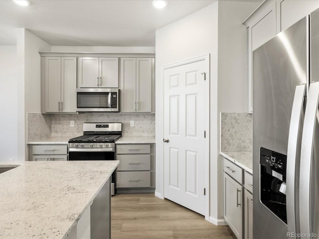 22360 E 8th Ave, Aurora, CO 80018 - kitchen with stainless steel appliances, tasteful backsplash, and gray cabinetry