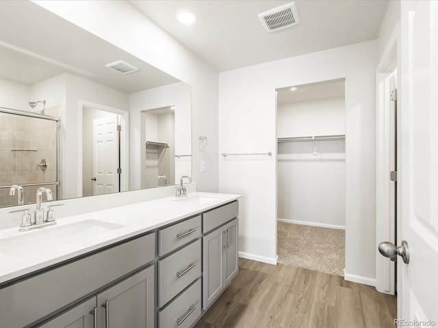 22360 E 8th Ave, Aurora, CO 80018 - bathroom with a sink, a shower stall, and visible vents