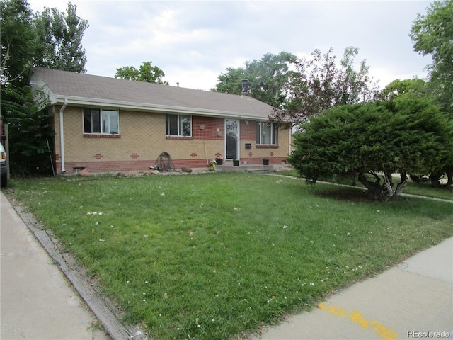 5640 E 67th Pl, Commerce City, CO 80022 - ranch-style house with brick siding, crawl space, roof with shingles, and a front lawn