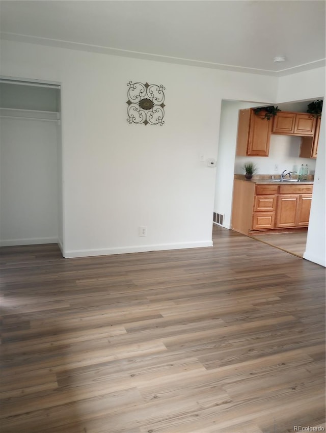 5640 E 67th Pl, Commerce City, CO 80022 - unfurnished dining area featuring visible vents, a sink, baseboards, and wood finished floors