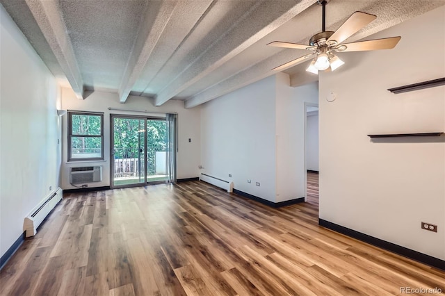 1265 Elizabeth St Unit 207, Denver, CO 80206 - spare room featuring a baseboard heating unit, a textured ceiling, a wall mounted air conditioner, beamed ceiling, and wood finished floors