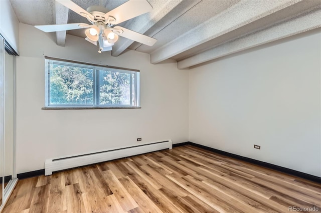 1265 Elizabeth St Unit 207, Denver, CO 80206 - unfurnished bedroom featuring a baseboard heating unit, beam ceiling, light wood-type flooring, a closet, and a ceiling fan