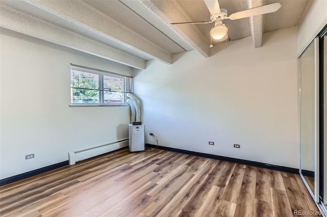 1265 Elizabeth St Unit 207, Denver, CO 80206 - unfurnished bedroom with baseboard heating, wood finished floors, ceiling fan, and a closet