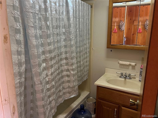 bathroom featuring vanity and shower / tub combo with curtain