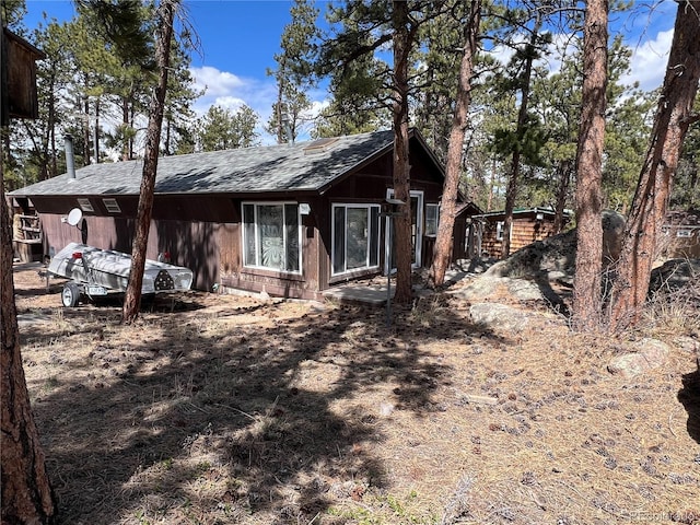 view of front of property featuring roof with shingles