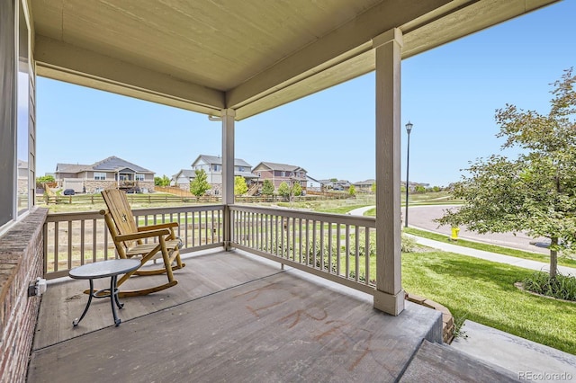 785 Iris St, Brighton, CO 80601 - wooden porch featuring a residential view and a lawn