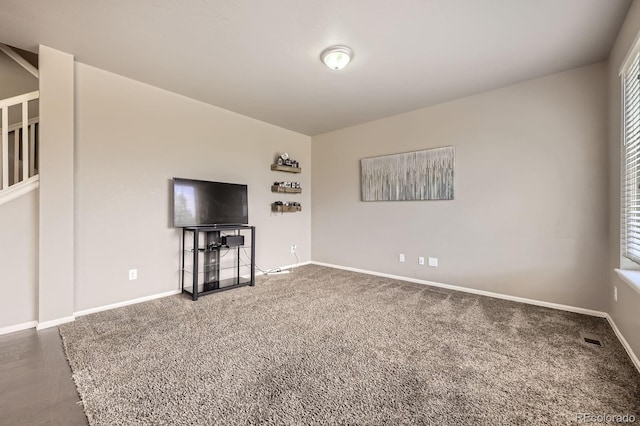 785 Iris St, Brighton, CO 80601 - unfurnished living room featuring carpet flooring and baseboards