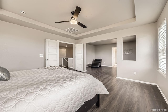 785 Iris St, Brighton, CO 80601 - bedroom with dark wood-type flooring, a raised ceiling, and a ceiling fan