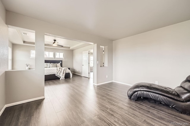 785 Iris St, Brighton, CO 80601 - bedroom with a tray ceiling, dark wood-type flooring, and a ceiling fan