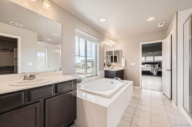 785 Iris St, Brighton, CO 80601 - bathroom featuring a shower stall, vanity, a garden tub, connected bathroom, and recessed lighting