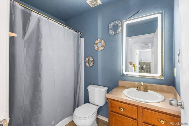 4528 Andes St, Denver, CO 80249 - full bathroom with toilet, vanity, and a shower with curtain