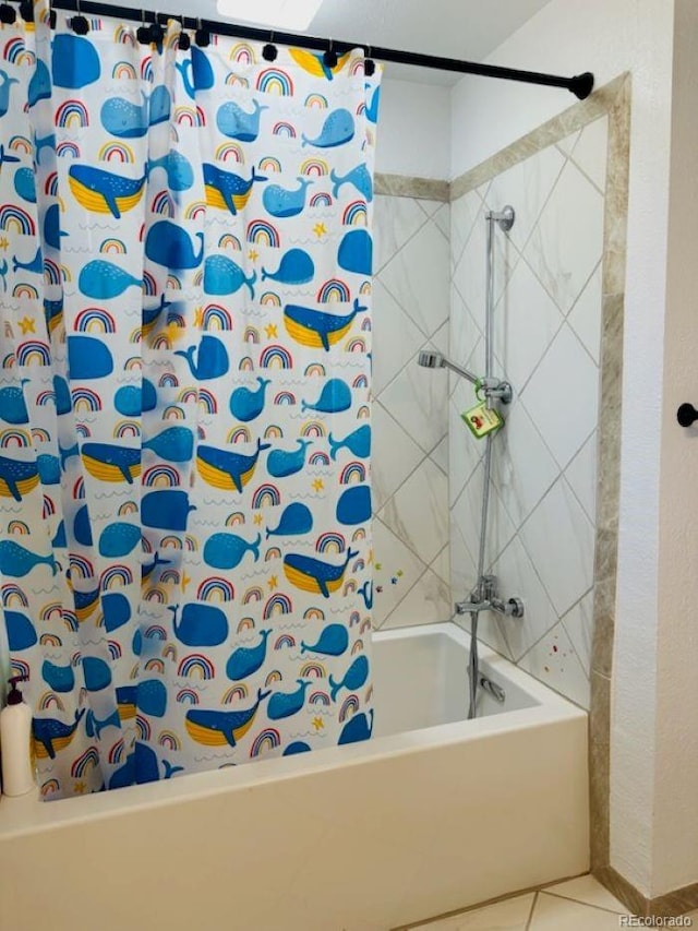 bathroom with tile patterned flooring and shower / bath combo with shower curtain