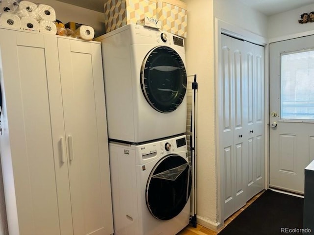 laundry room featuring laundry area and stacked washer / dryer