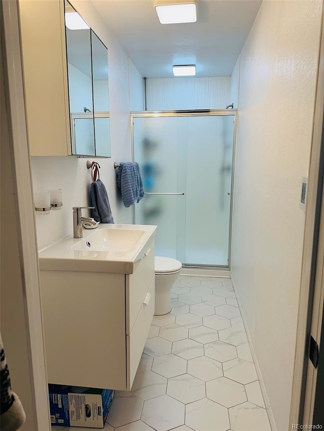 bathroom featuring a stall shower, vanity, and toilet