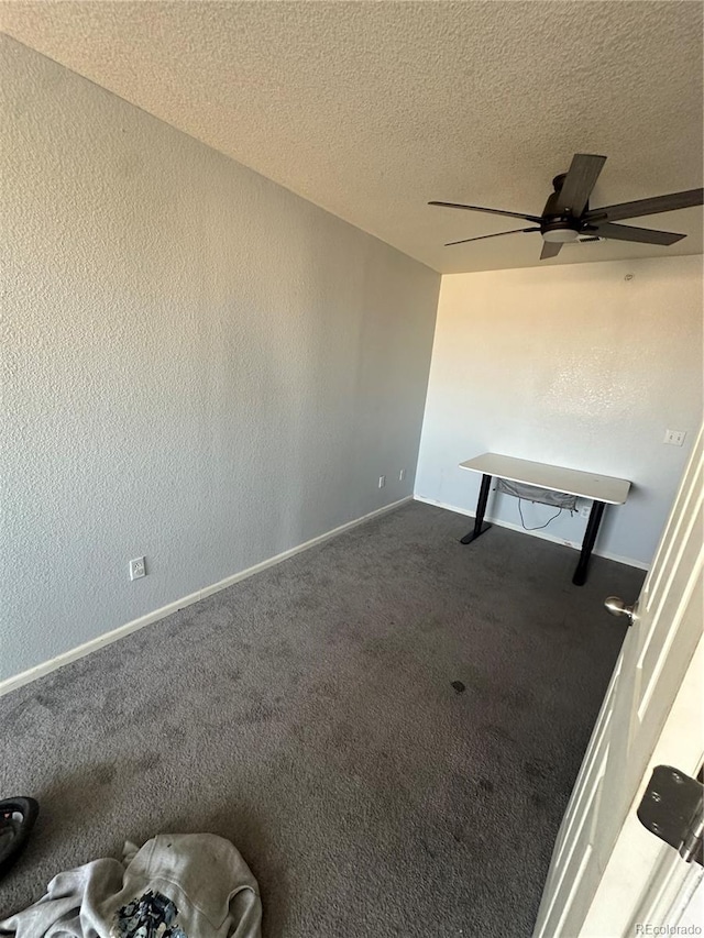 5255 Memphis St Unit 121, Denver, CO 80239 - spare room with dark carpet, a textured ceiling, a ceiling fan, and baseboards