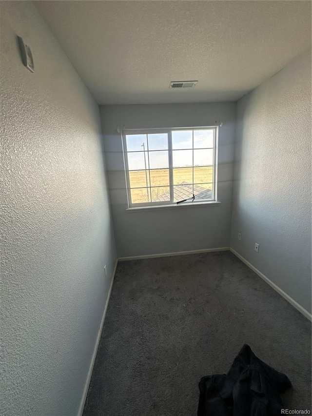 5255 Memphis St Unit 121, Denver, CO 80239 - carpeted spare room with baseboards, a textured wall, and a textured ceiling