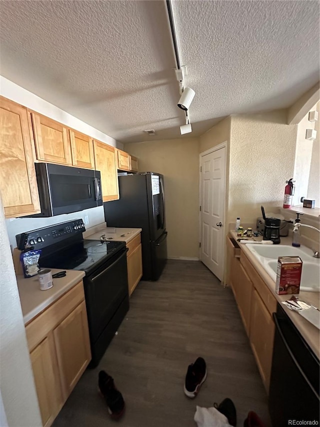 5255 Memphis St Unit 121, Denver, CO 80239 - kitchen featuring black appliances, a textured ceiling, a sink, wood finished floors, and track lighting