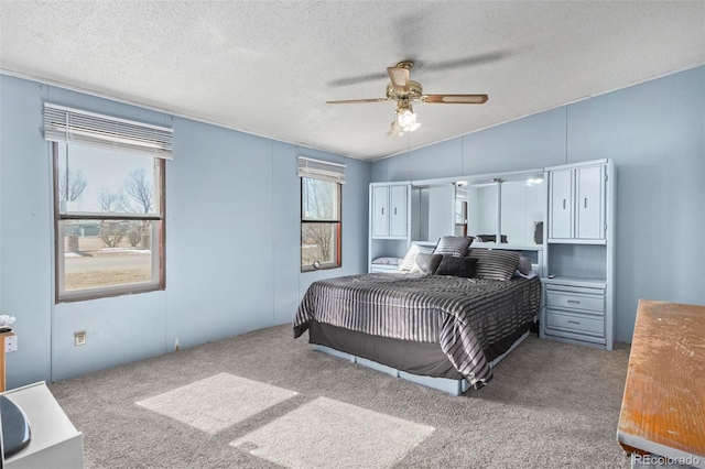 bedroom with a textured ceiling, ceiling fan, light carpet, and lofted ceiling