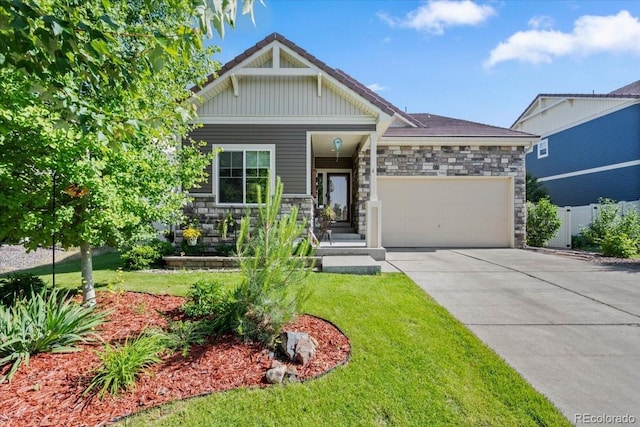 5100 Eaglewood Ln, Johnstown, CO 80534 - craftsman-style home featuring an attached garage, stone siding, concrete driveway, and board and batten siding