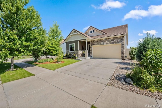 5100 Eaglewood Ln, Johnstown, CO 80534 - craftsman house with stone siding, a garage, driveway, and covered porch