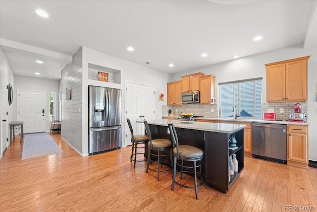 5100 Eaglewood Ln, Johnstown, CO 80534 - kitchen featuring stainless steel appliances, light wood finished floors, a center island, backsplash, and recessed lighting