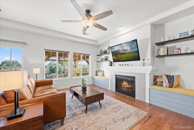 5100 Eaglewood Ln, Johnstown, CO 80534 - living area featuring wood finished floors, a tile fireplace, and ceiling fan