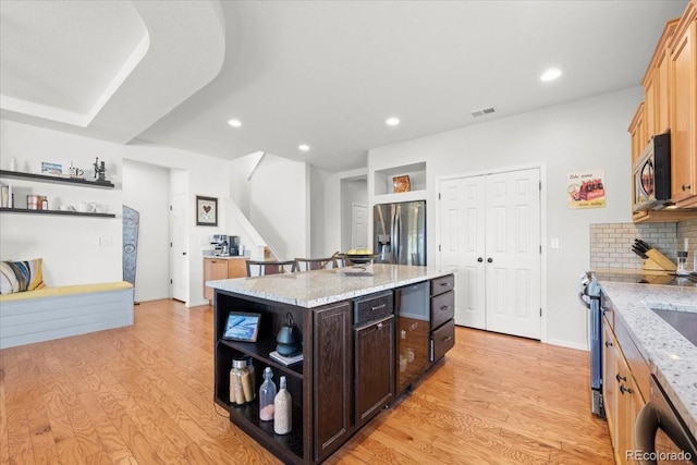 5100 Eaglewood Ln, Johnstown, CO 80534 - kitchen featuring appliances with stainless steel finishes, open shelves, light wood-style flooring, a center island, and recessed lighting