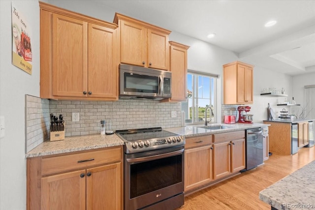 5100 Eaglewood Ln, Johnstown, CO 80534 - kitchen featuring stainless steel appliances, light wood-type flooring, light brown cabinetry, decorative backsplash, and light stone counters