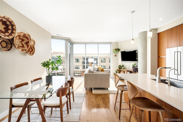 4200 W 17th Ave Unit 611, Denver, CO 80204 - dining room featuring light wood-style flooring and floor to ceiling windows