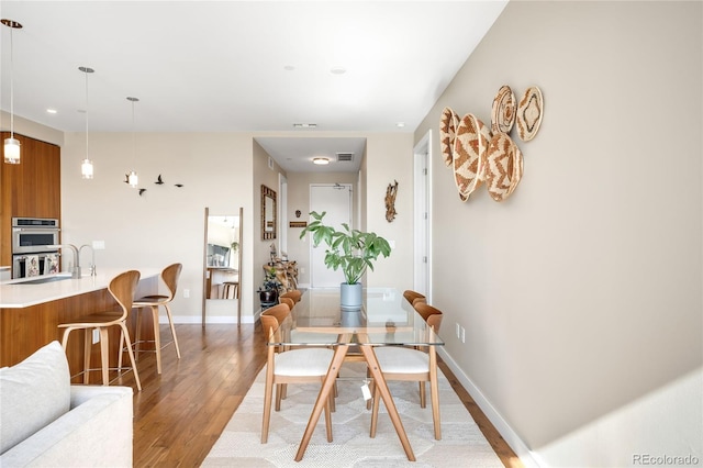 4200 W 17th Ave Unit 611, Denver, CO 80204 - dining space with light wood finished floors, baseboards, and recessed lighting