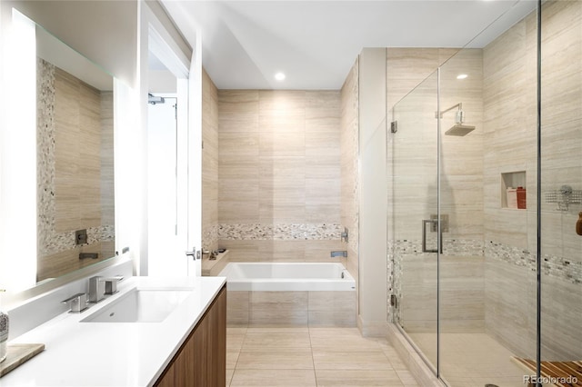 4200 W 17th Ave Unit 611, Denver, CO 80204 - bathroom with vanity, a bath, a stall shower, tile patterned floors, and recessed lighting