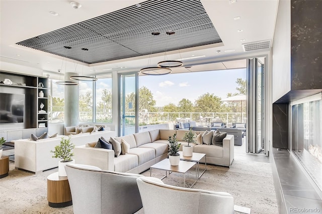 4200 W 17th Ave Unit 611, Denver, CO 80204 - living room with a raised ceiling, expansive windows, and healthy amount of natural light