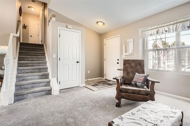 living area with baseboards, stairway, carpet floors, and lofted ceiling