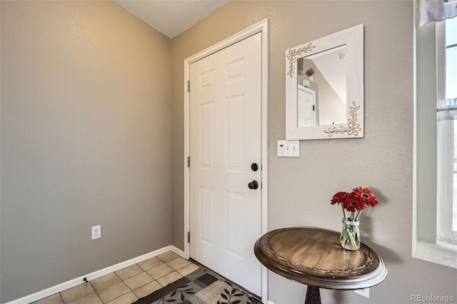 entrance foyer featuring light tile patterned floors and baseboards