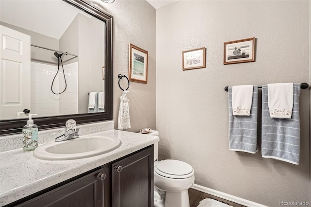 full bathroom featuring toilet, wood finished floors, a shower, vanity, and a textured wall