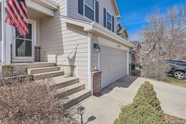 view of property exterior featuring concrete driveway and an attached garage