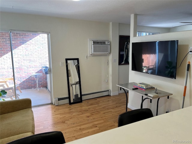 living room with a wall mounted air conditioner, a healthy amount of sunlight, light wood-type flooring, and a baseboard radiator