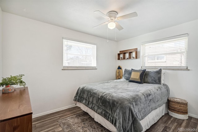 bedroom with multiple windows, dark hardwood / wood-style floors, and ceiling fan