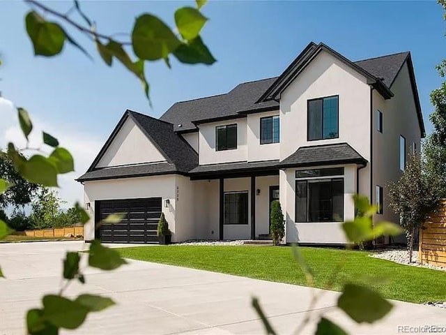 view of front of property with a front yard and a garage